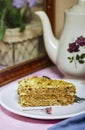 walnut dacquoise cake or Kiev cake with meringue layers and vanilla buttercream with coffee near window.