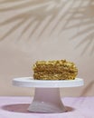 walnut dacquoise cake or Kiev cake with meringue layers and vanilla buttercream served on white stand cake
