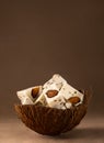 Walnut Halva with almonds in a coconut shell