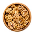 Walnut kernel halves, shelled and dried seeds, in a wooden bowl