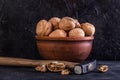 Walnut and hammer in clay with broken walnut Royalty Free Stock Photo