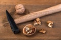 Walnut and hammer on a wooden board Royalty Free Stock Photo
