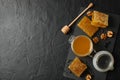 Walnut, honeycombs, jar with honey and dipper on black background Royalty Free Stock Photo