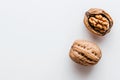 A walnut and its kernel are shown in isolation on a white background Royalty Free Stock Photo
