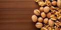 Walnut kernel halves in a wooden bowl Close up from above on colored background 4