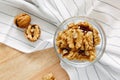 Walnut kernels lie in round bowl on kitchen table, close-up. View from above. Healthy lifestyle concept. Royalty Free Stock Photo