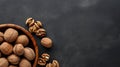 Walnut kernels and whole walnuts on dark stone table. Black background. Top view, flat lay with copy space. Generative Ai