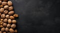 Walnut kernels and whole walnuts on dark stone table. Black background. Top view, flat lay with copy space. Generative Ai