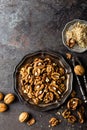 Walnut kernels and whole walnuts on rustic old table Royalty Free Stock Photo