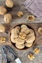 Walnut kernels and whole walnuts on a wooden table. View from above. Nuts and nutcracker on a wooden background. Royalty Free Stock Photo