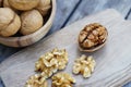 Walnut nut in wooden bowl on wood table with green leaf background, copy space Royalty Free Stock Photo