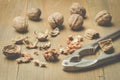 Walnut. nutcracker and the split walnut on a wooden background Royalty Free Stock Photo