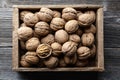 Walnut nuts in a wooden box on old wooden table