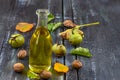 Walnut oil- bottle of walnut oil with freh walnuts around Royalty Free Stock Photo