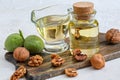 Walnut oil in a bottle and a glass cup. Royalty Free Stock Photo