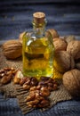 Walnut oil in bottle and nuts Royalty Free Stock Photo