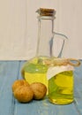 walnut oil in glass bottle on blue wooden background Royalty Free Stock Photo