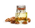 Walnut oil with nuts on a wooden background Royalty Free Stock Photo