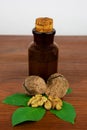 Walnut oil and nuts on wooden table Royalty Free Stock Photo