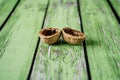 Walnut shells on green wooden boards. Royalty Free Stock Photo