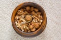 Walnut in vintage wooden nut bowl with cracked walnut and peanut