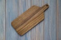 Walnut wood cutting board on a wooden gray background Royalty Free Stock Photo
