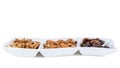 Walnuts almonds and dates in a white dish Royalty Free Stock Photo