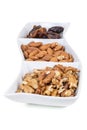 Walnuts almonds and dates in a white dish Royalty Free Stock Photo