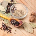 Walnuts, black pepper, bay leaf on a wooden table. Royalty Free Stock Photo