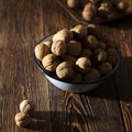 Walnuts in a blue plate on a wooden table Royalty Free Stock Photo