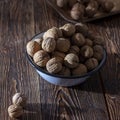 Walnuts in a blue plate on a wooden table Royalty Free Stock Photo