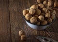 Walnuts in a blue plate on a wooden table Royalty Free Stock Photo