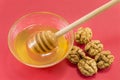 Walnuts and bowl of honey on a table Royalty Free Stock Photo