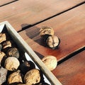 Walnuts in a box on the background of a wooden table