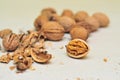 Walnuts on bright desk. Whole walnut and open ones and shells.