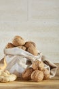 Walnuts in burlap bag on wooden table over the light background, selective focus, close-up. Royalty Free Stock Photo