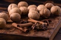 Walnuts, cinnamon and anise on wooden cutting board. Nuts and spices on the table. Food composition close-up. Royalty Free Stock Photo