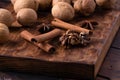 Walnuts, cinnamon and anise on wooden cutting board. Nuts and spices on the table. Food composition close-up. Royalty Free Stock Photo