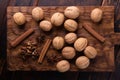 Walnuts, cinnamon and anise on wooden cutting board. Nuts and spices on the table. Food composition. Royalty Free Stock Photo