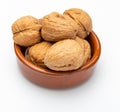 Walnuts in clay bowl Various nuts collection. Royalty Free Stock Photo