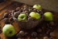 Walnuts with green apples mixed with a wicker basket Royalty Free Stock Photo