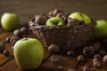 Walnuts with green apples mixed with a wicker basket Royalty Free Stock Photo