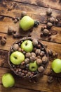 Walnuts with green apples mixed with a wicker basket Royalty Free Stock Photo