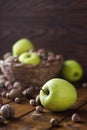 Walnuts with green apples mixed with a wicker basket Royalty Free Stock Photo