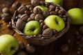 Walnuts with green apples mixed with a wicker basket Royalty Free Stock Photo