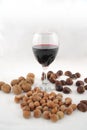 Walnuts, hazelnuts, chestnuts and glass of wine Royalty Free Stock Photo