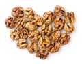 Walnuts kernels lined with hearts on a white background. Top view Royalty Free Stock Photo