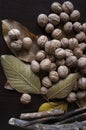 Walnuts, leaves and twigs on a dark background