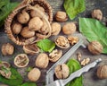 Walnuts, nutcracker and basket on old table, top view. Royalty Free Stock Photo