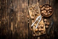 Walnuts with Nutcracker on the Board. Royalty Free Stock Photo